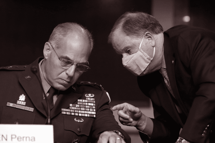 General Gustave F. Perna at a meeting