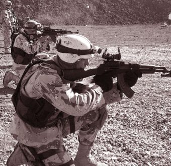 Soldiers with guns training at target practice