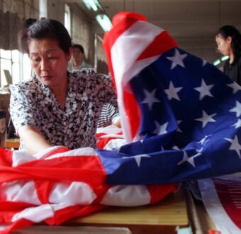 A seamstress at Chinese factors sews an American flag