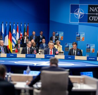 President Donald Trump sits among European leaders in a North Atlantic Council Plenary Session.