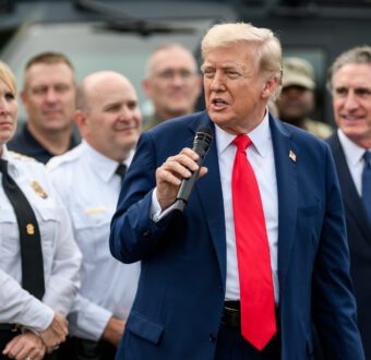 President Trump speaks in front of a crowd of law enforcement officers, military members, and staffers.